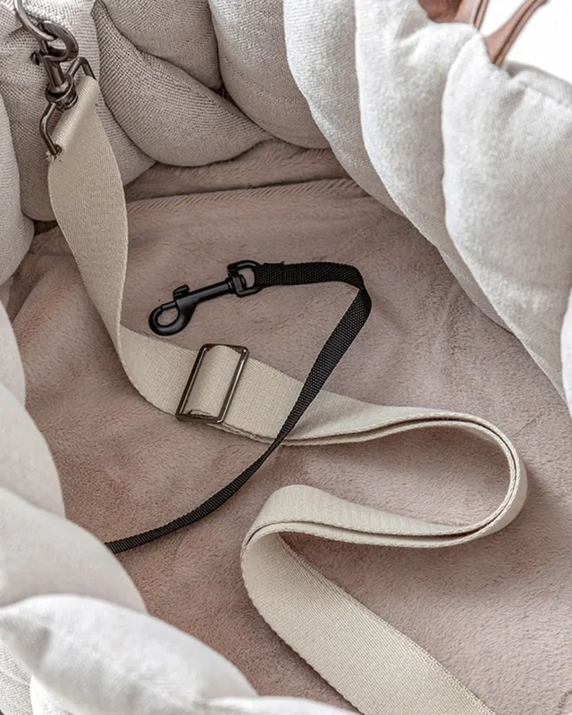 Interior of Coquille French Bulldog Carrier Bag showing built-in safety leash clip and plush lining with adjustable strap