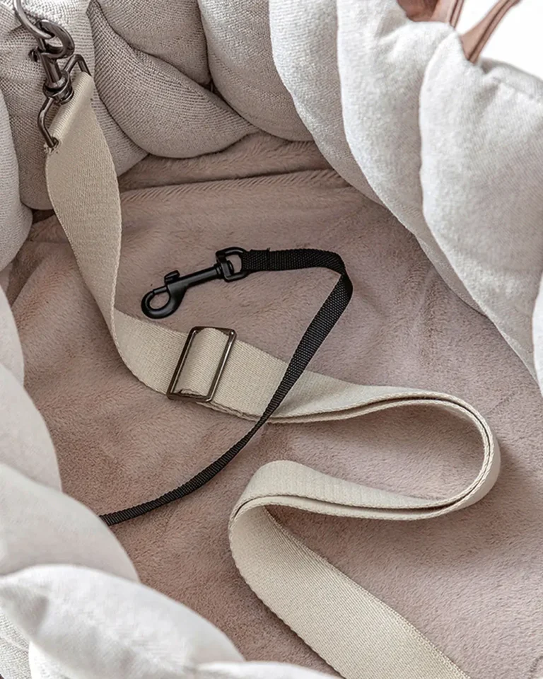 Interior of Coquille French Bulldog Carrier Bag showing built-in safety leash clip and plush lining with adjustable strap